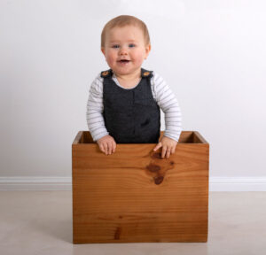 Toddler in wooden box